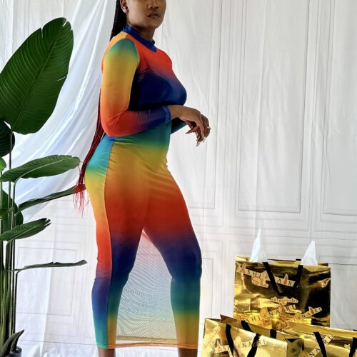 Woman modeling a rainbow colored mesh beach cover up